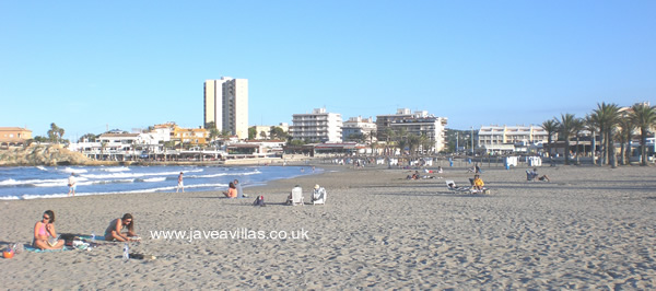 sunbathing on Javea's arenal beach in late September